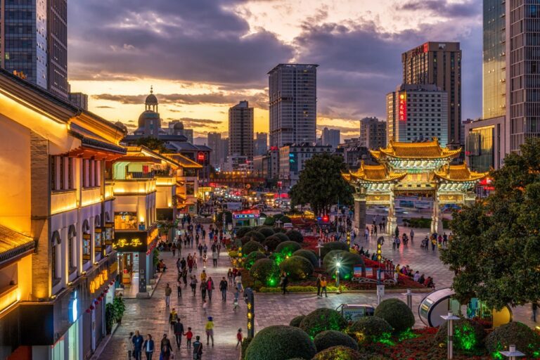 KUNMING, CHINA - OCT 2019 : Top view of Jinbi Square which have Golden Horse and Jade Rooster archway in sunset time on October 19, 2019 at Kunming,China