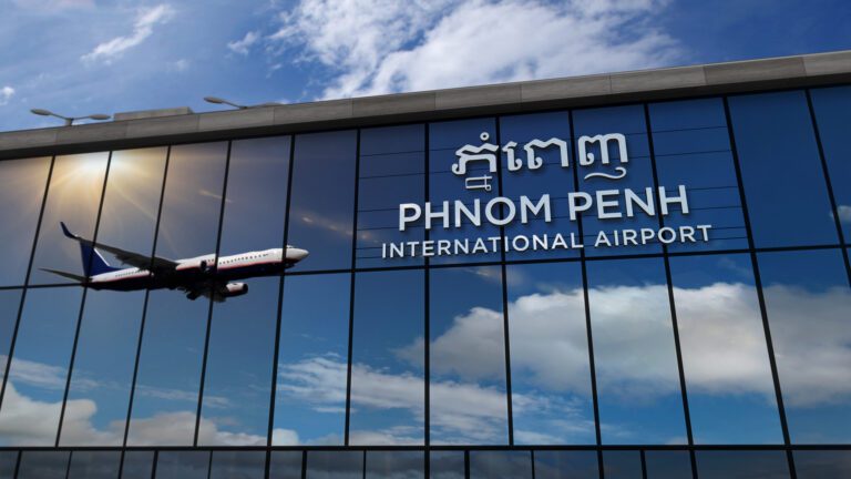 Airplane landing at Phnom Penh Cambodia airport mirrored in terminal